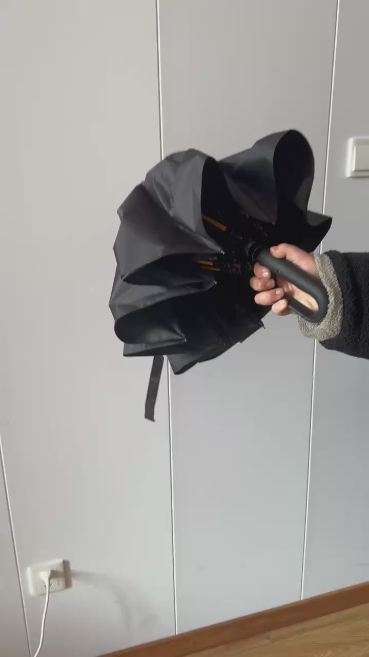The umbrella opening and closing at the press of the button