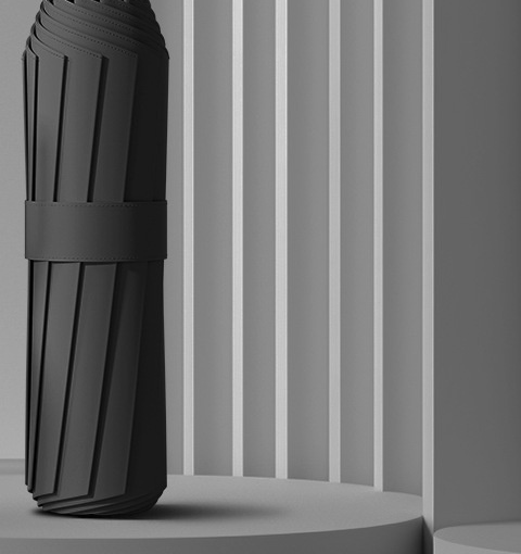 Folded black canopy held by its strap